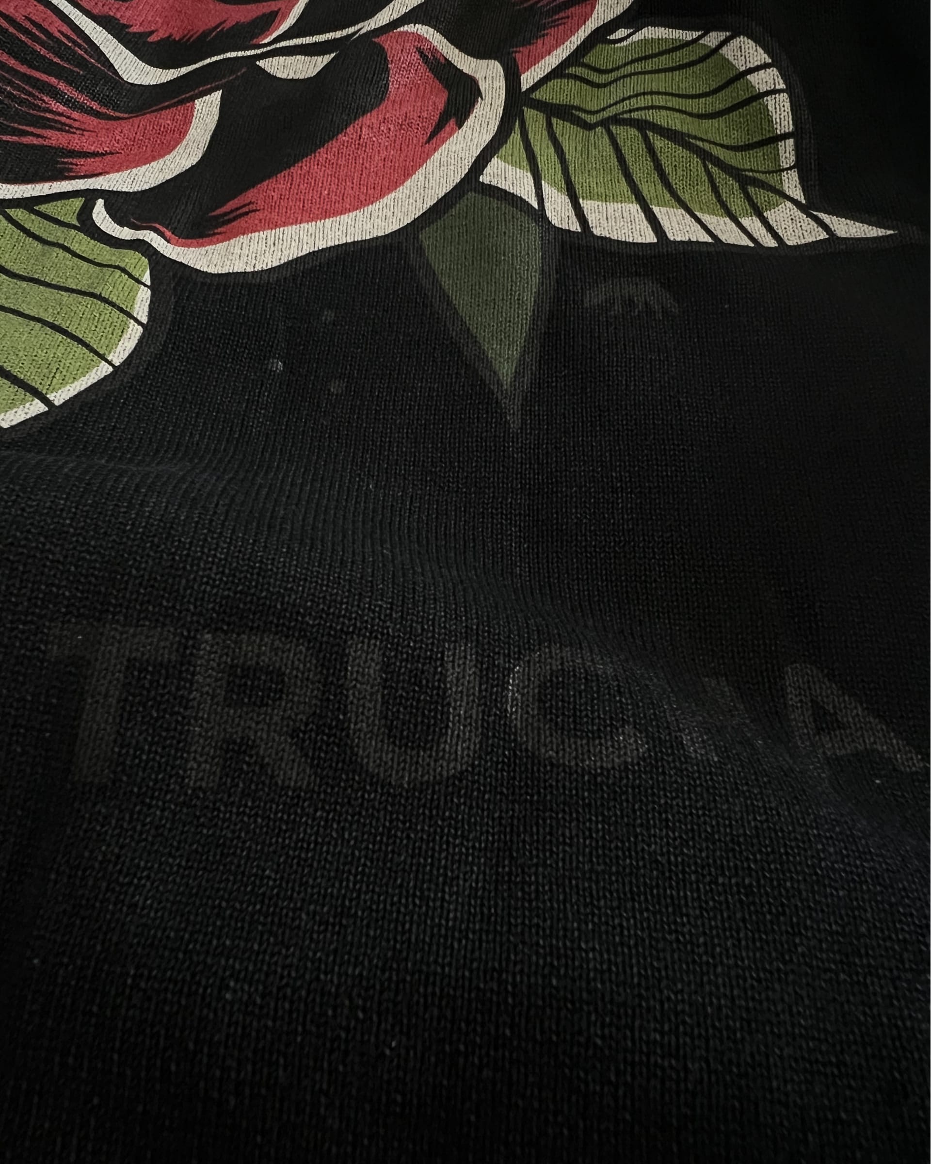 Close-up of black mineral wash oversized sweater graphic printed on back