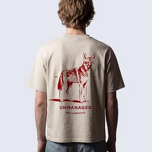 Back of FERN + FIN UNMANAGED t-shirt in light apricot with coyote graphi