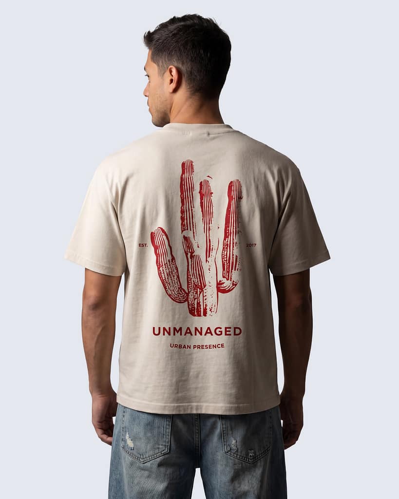 Back of FERN + FIN UNMANAGED t-shirt in light apricot with cactus graphic